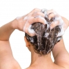 Woman washing her hair in 3DHair shampoo.